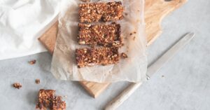 Delicious homemade granola bars on a wooden board, perfect for healthy snacking and meal preparation.